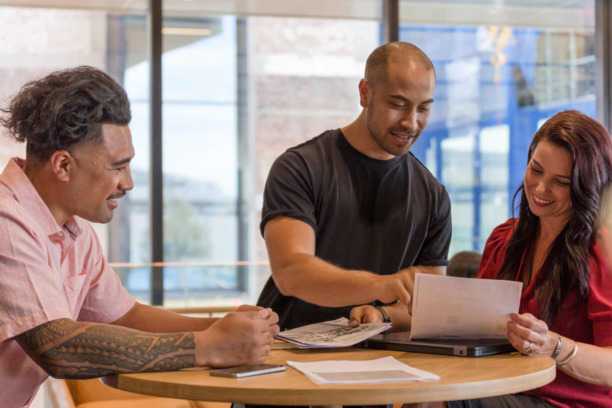 Three people people meeting over a table