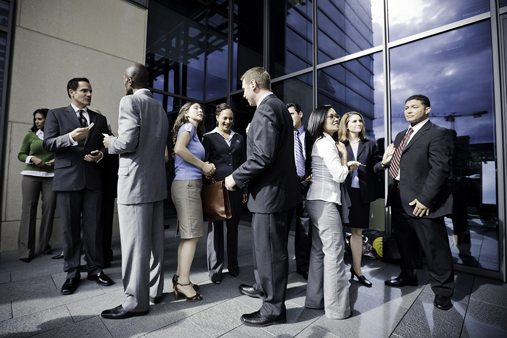Image of business people standing outside of a building