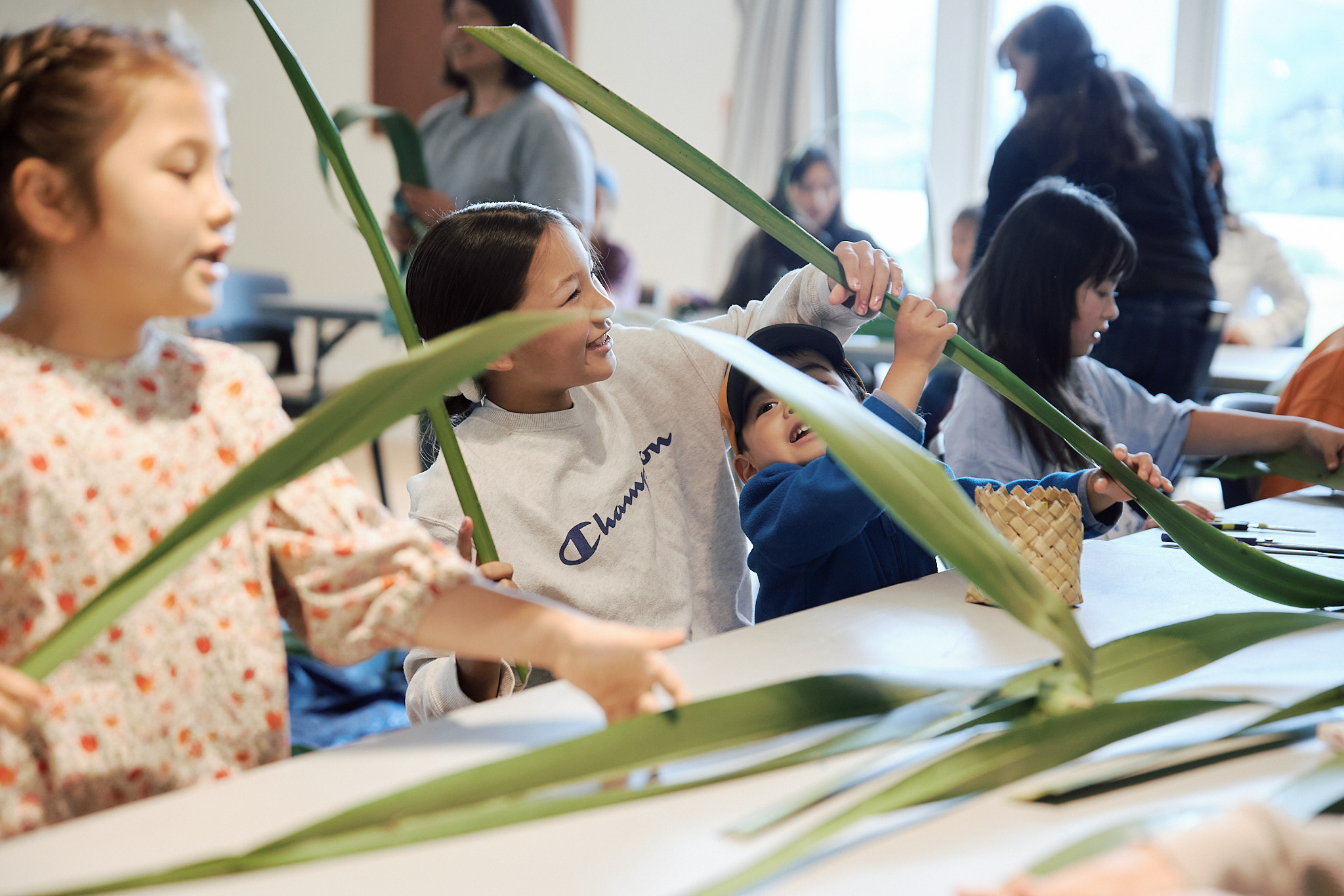 Children during a Māori flax weaving workshop. 