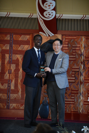 High school student Leo Mwape poses with Engagement Advisor Sean Lim. They are holding the Tohu Whetumatarau- Ministry for Ethnic Communities Award for Vision, which Leo was awarded for his Race Unity Speech Awards speech