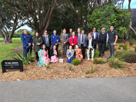 Members behind Mokopuna the tree that was planted within the Treaty grounds