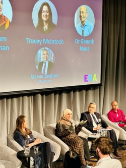 Photograph of Professor Tracey McIntosh, Dr Ganesh Nana, Anjum Rahman and Mervin Singham sitting on stage engaging in conversation.