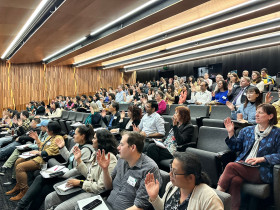 Photograph of participants seated in the auditorium.